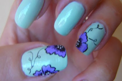 Cute blue nail art design with purple/black flower